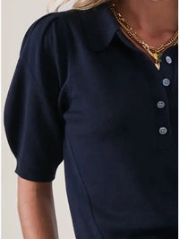 Detail shot of navy puff sleeve polo with pointelle stitching