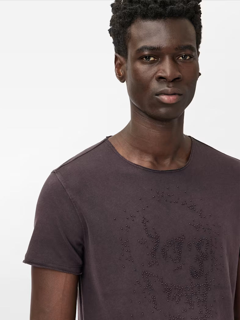Close-up of hand-beaded skull artwork on short sleeve tee
