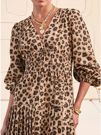 Close-up of elasticized cuffs and V-neckline tie on leopard print dress