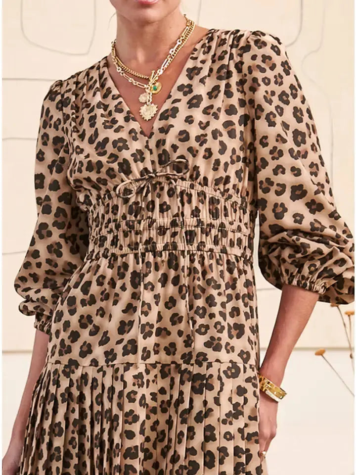 Close-up of elasticized cuffs and V-neckline tie on leopard print dress