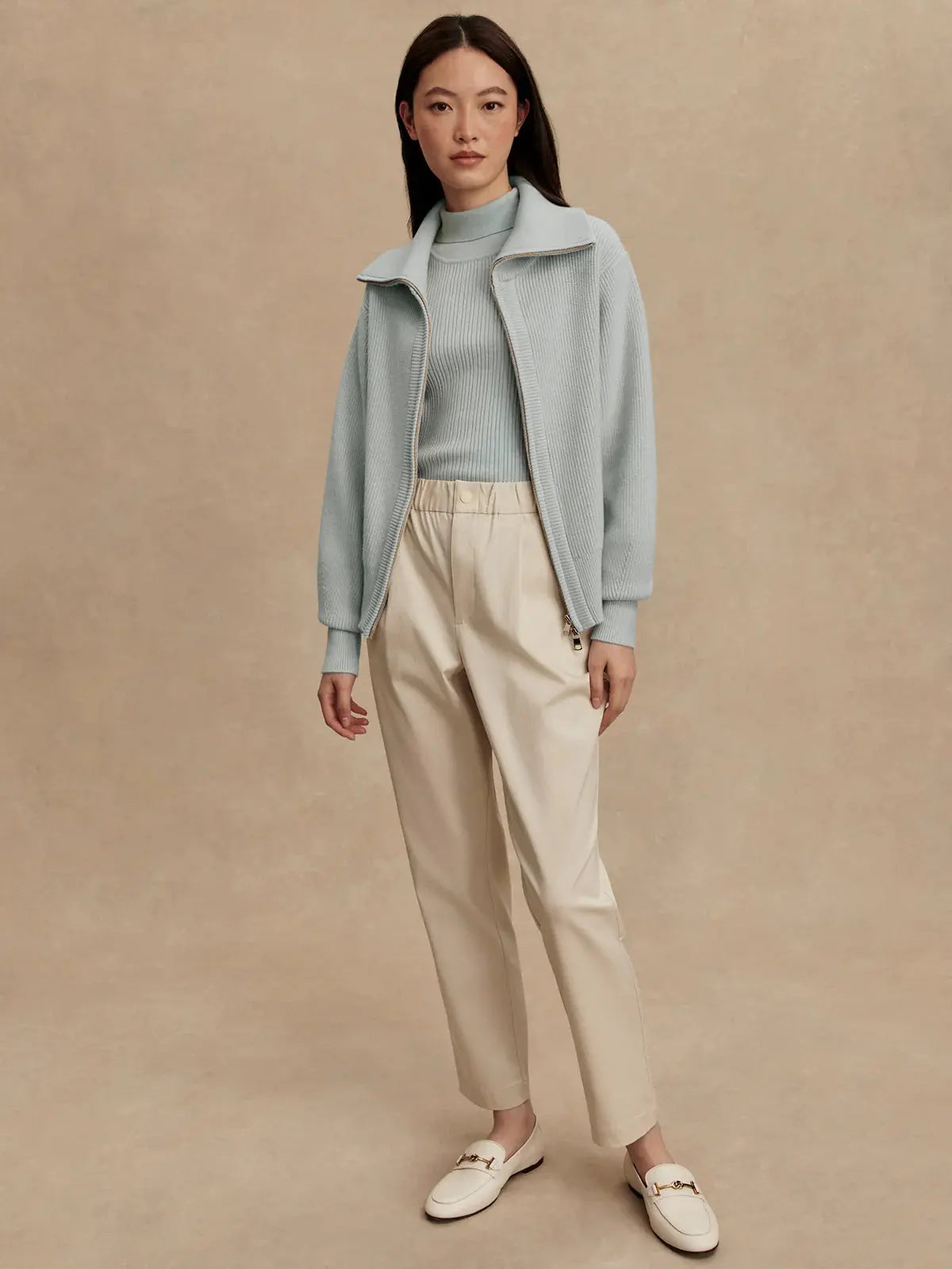 Model wearing Enrico Knit Jacket in Winter Sky, styled for fall athleisure