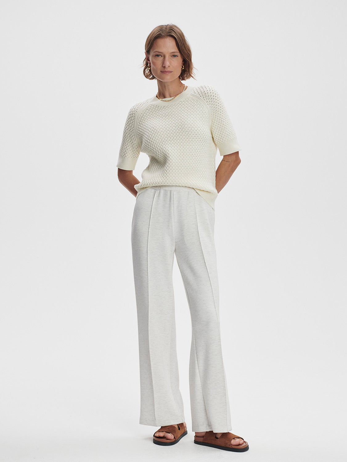 “Model wearing Varley Lucy Knit Top styled casually with jeans
