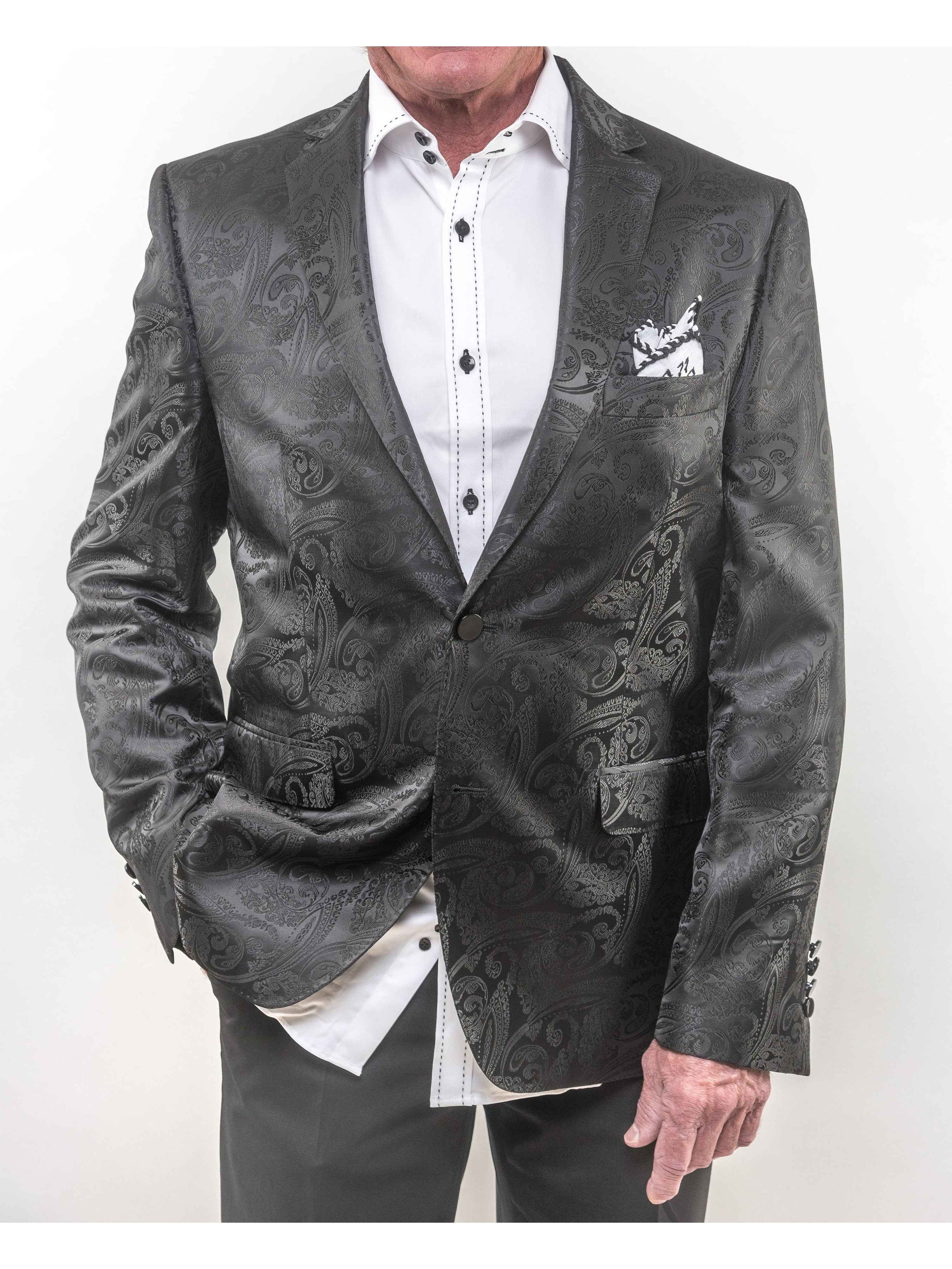 Close-up of Lansky Bros. Limited Edition Wedding Jacket with white saddle stitch shirt underneath, showcasing the black paisley design and Clothier to the King label.