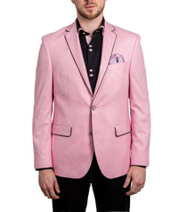 Man wearing a pink blazer over a black shirt with a white background