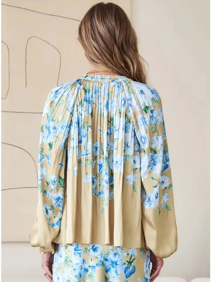 Back detail of floral printed blouse – soft pleats and neutral tones