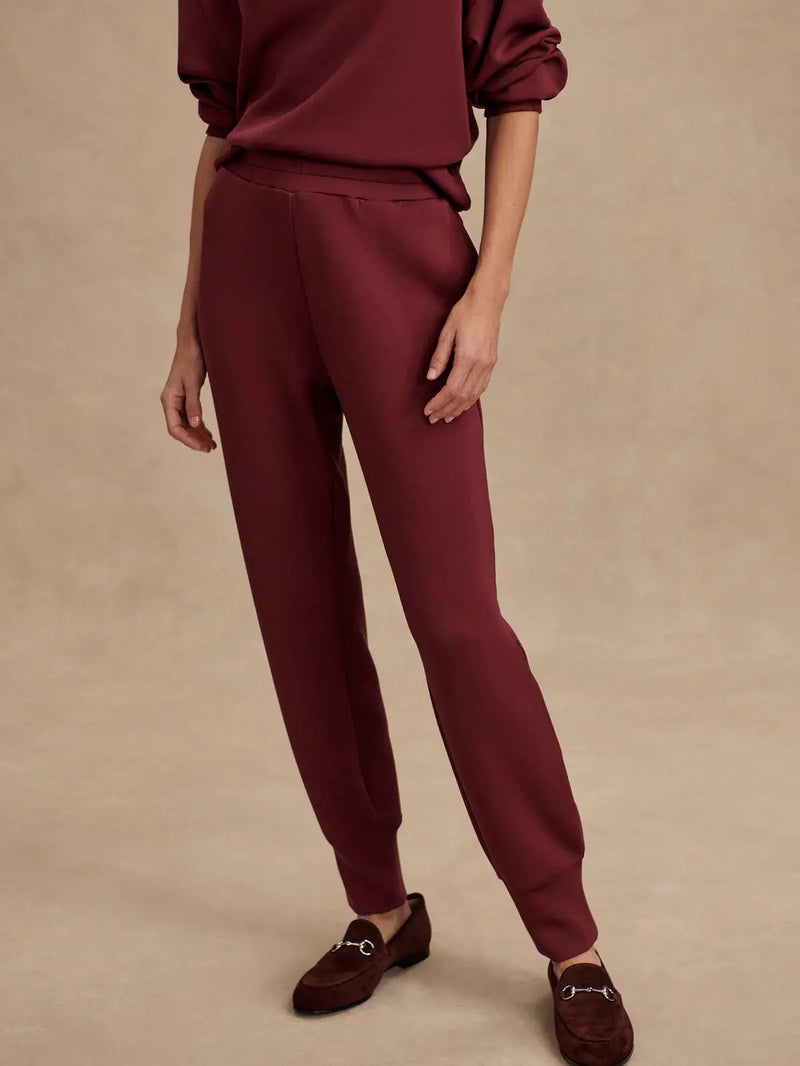 Front view of Varley Slim Cuff Pant 25" in New Maroon, slim tailored fit with cuffed hem