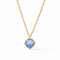 The Honeybee Solitaire Necklace - Iridescent Chalcedony Blue features a 24K gold plate chain and a round, faceted light blue gemstone pendant in a simple gold bezel. This adjustable necklace adds refined elegance to any look.