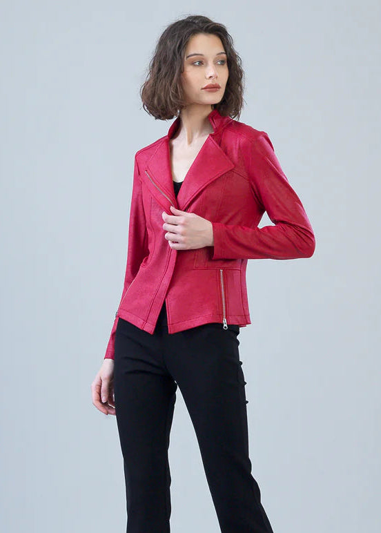 Woman wearing a red jacket and black pants on a gray background