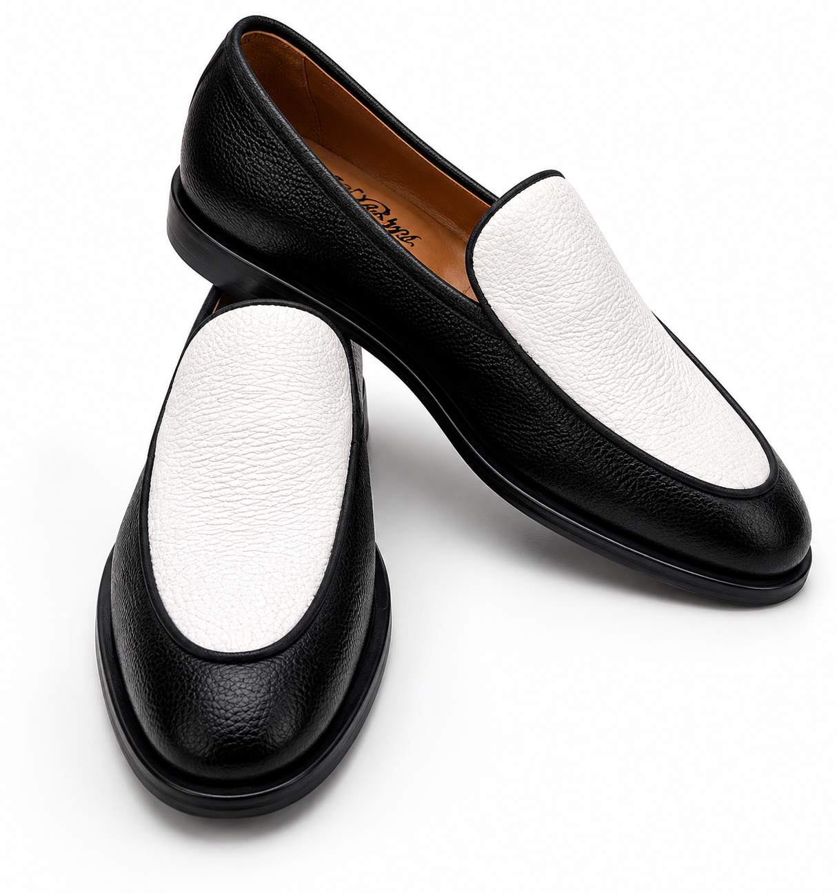 Black and white loafers on a white background